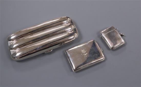 An Edwardian silver three-division cigar case, Birmingham 1903 and two silver vesta cases.